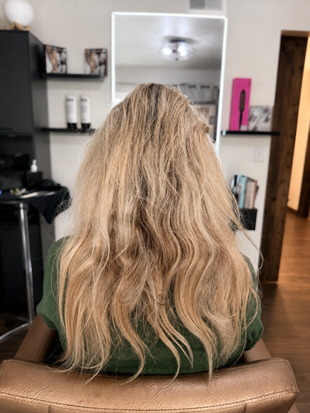 Before photo showing blonde hair's natural texture prior to a keratin smoothing treatment