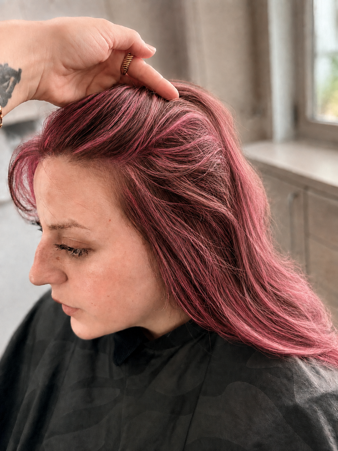 After close-up showing rose pink dimensional color at the roots and client's face