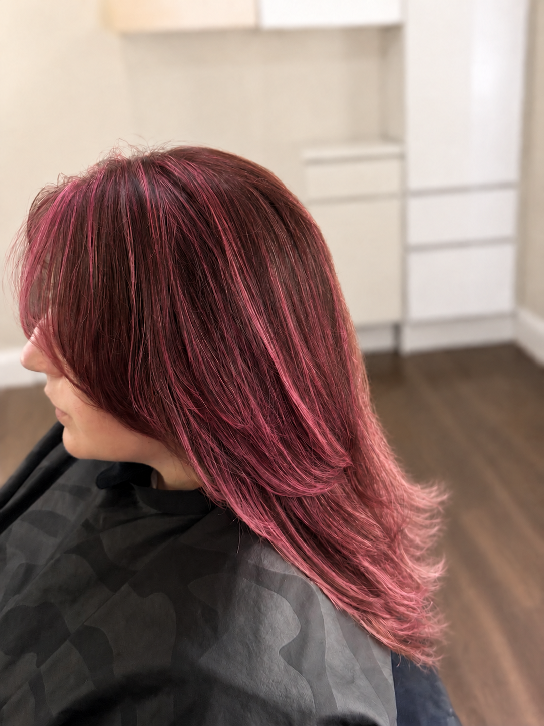 After side view of rose pink layered haircut and color by Hayley